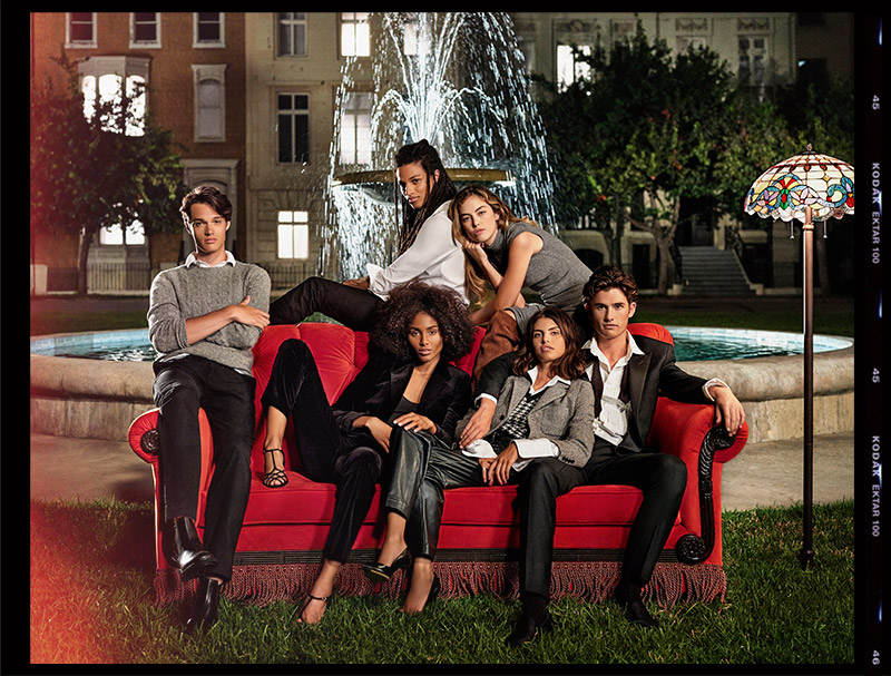Models channeling Friends cast around water fountain with red couch