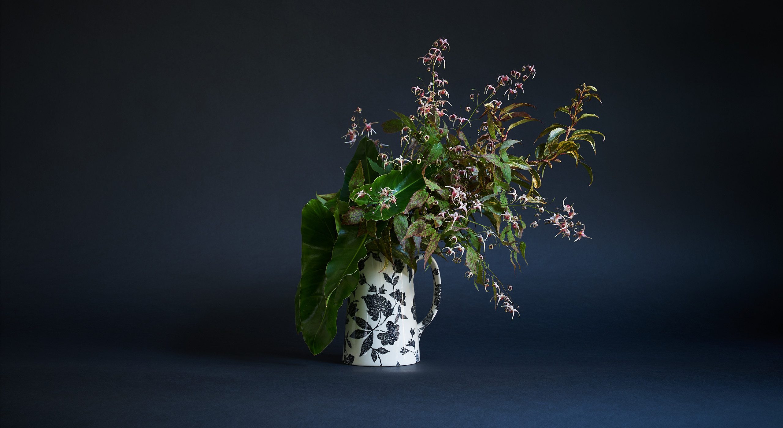 “This is a perfect choice if somebody was looking to create an arrangement with a woodland feel. At the heart of this one is epimedium, which is actually a very common garden flower that has beautiful foliage and a short blooming season in the spring. It’s all about the texture and speckling, which is something I come back to again and again. With everything I do, I want people to have to look a little harder than they usually might. This also has Leucothoe—a common shrub that’s very hardy and often overlooked—as well as philodendron, a houseplant that’s super long-lasting in the vase. I’ve tried to transform them from appearing waxy and tropical to something you might discover in a wetland bog.”