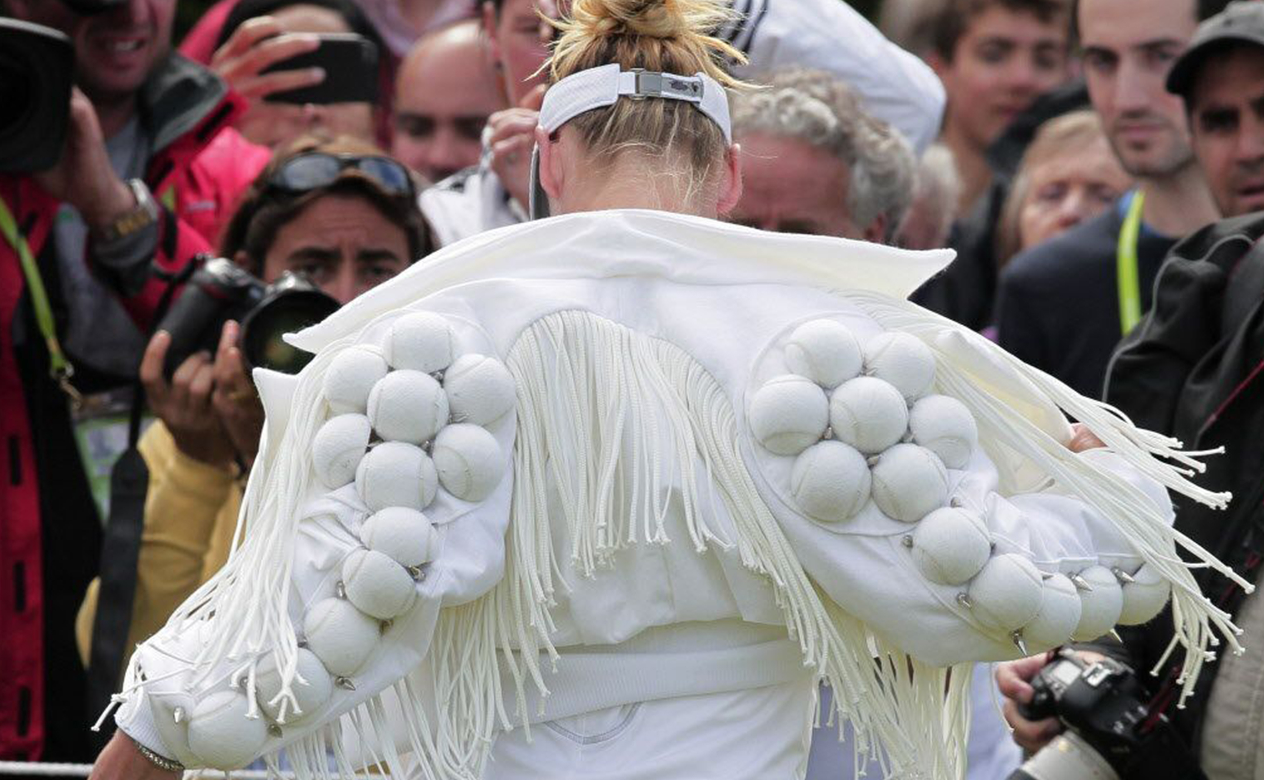 Bethanie Mattek-Sands wears a fringed jacket decorated with white tennis balls in 2011