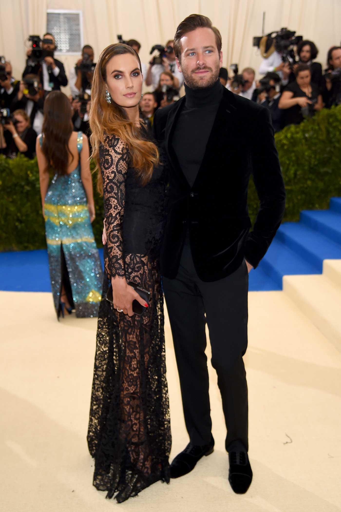Armie Hammer sported a velvet dinner jacket, a turtleneck, and tuxedo pants from Ralph Lauren Purple Label. Elizabeth Chambers wore a Ralph Lauren Collection lace evening dress