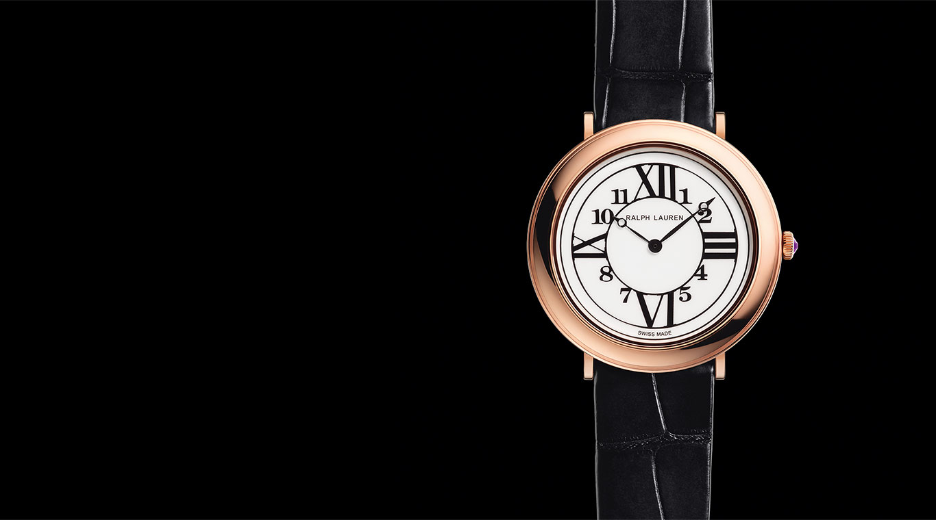 Close-up of rose-gold watch with black alligator wrist strap