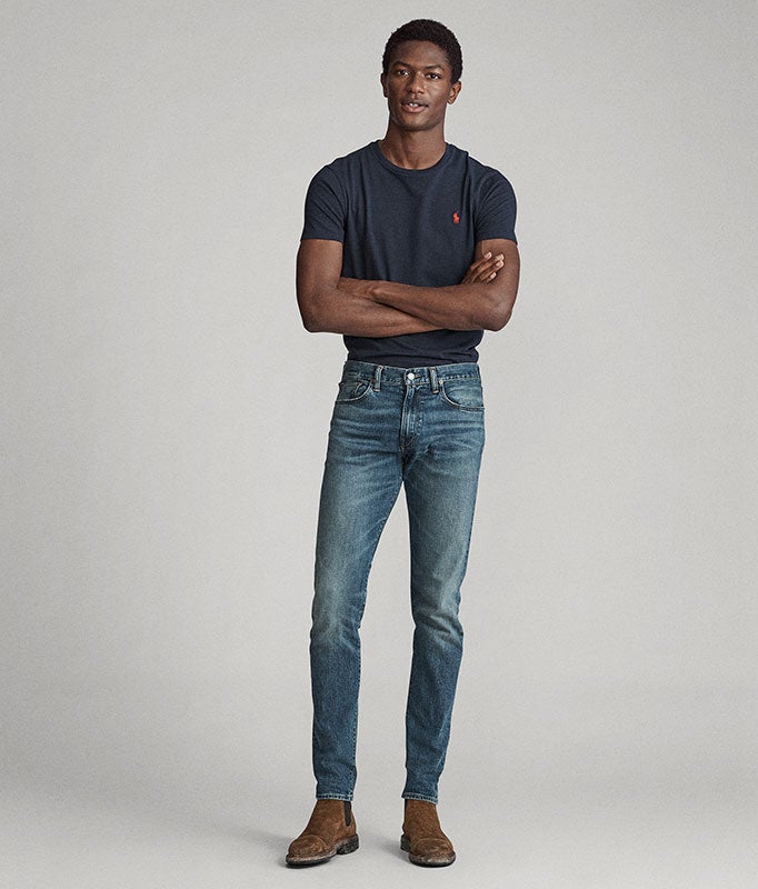 Man in skinny jeans & navy tee with red Polo Pony embroidery