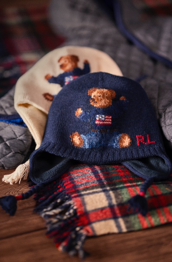 Navy & cream earflap hats featuring knit Polo Bear motifs.