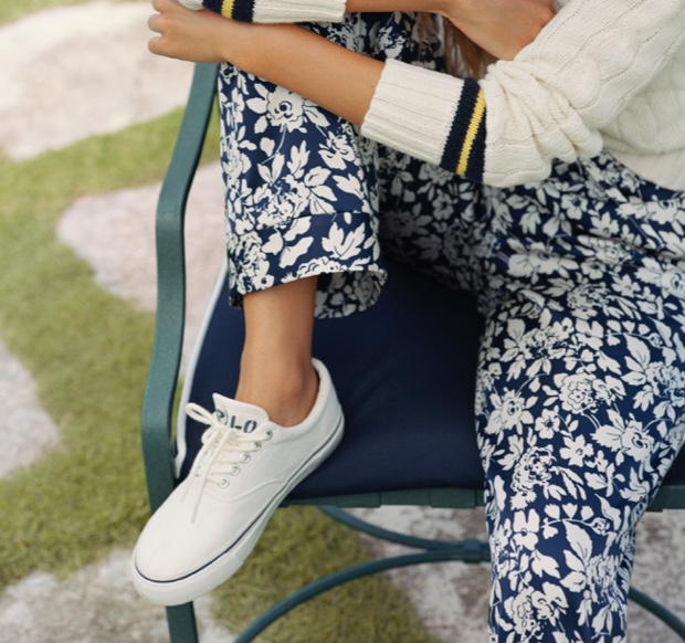 Woman wearing floral-print pants & white Polo lace-up sneakers