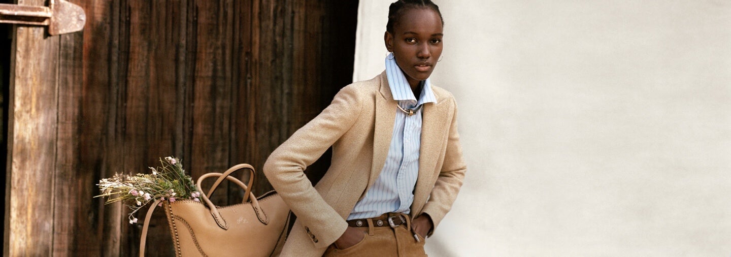 Woman in Western-inspired tan coat & pants & striped shirt