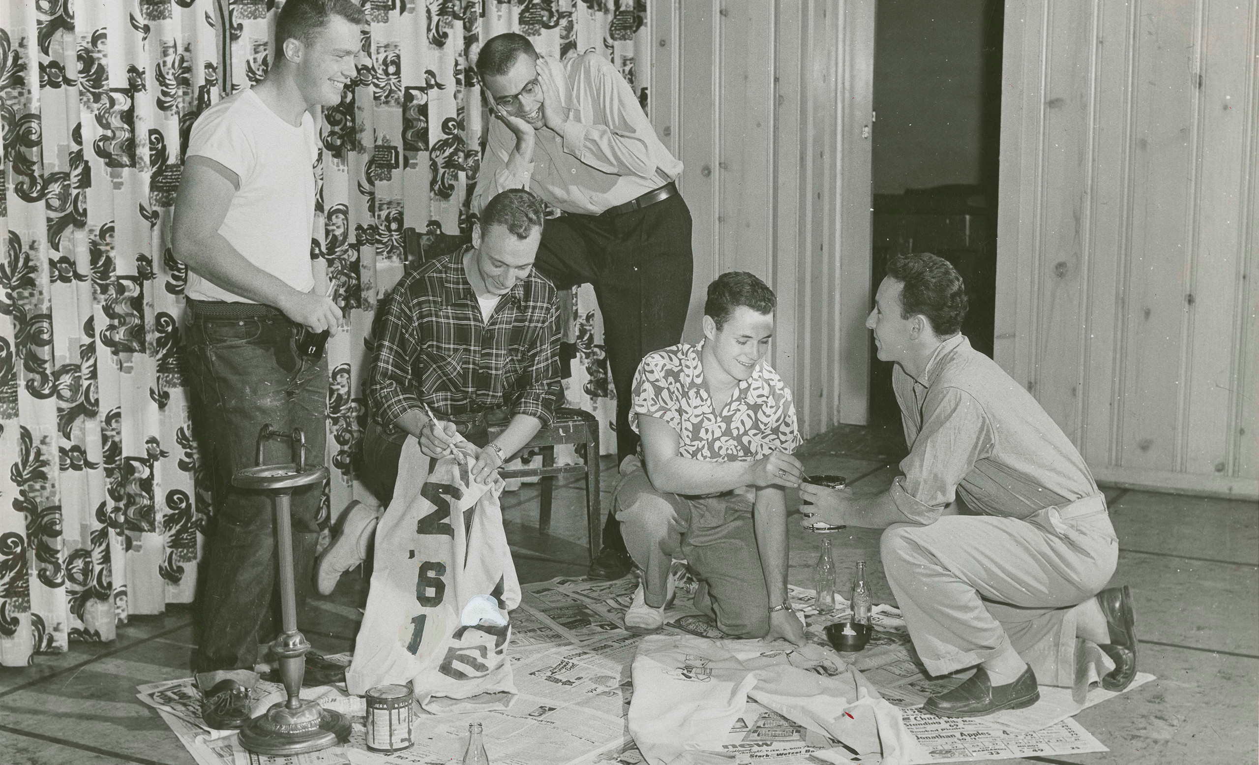 Members of the class of 1961 work on their cords
