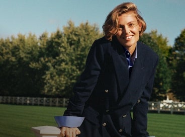 Woman wears navy double-breasted blazer.