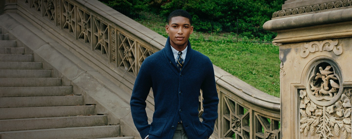 Man in navy shawl cardigan layered with shirt & tie
