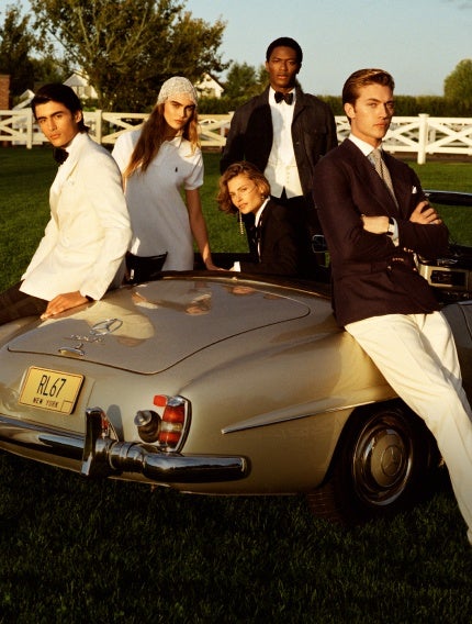 Models around a car at the Hamptons.