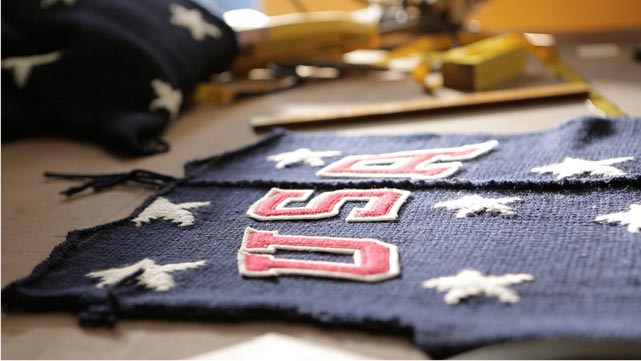 Patches, sketches and other sources of inspiration for Ralph Lauren&#x2019;s official Team USA Opening Ceremony Cardigan cover a design table at company headquarters
