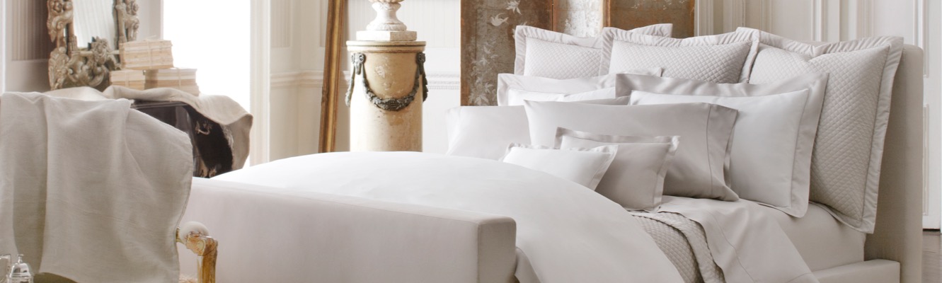 Bed topped with white sateen duvet.