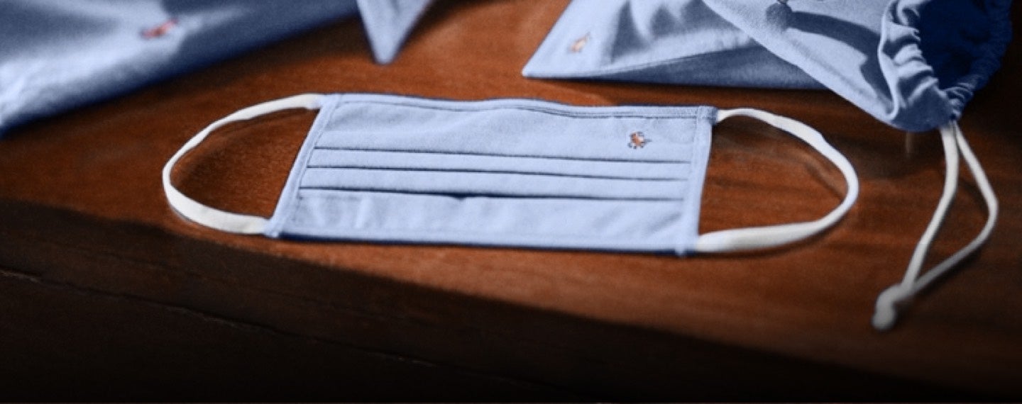 Polo cloth face mask on desk.