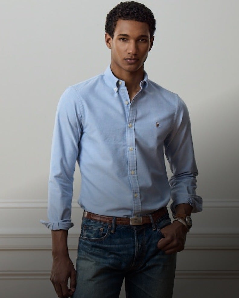 Man wears blue Slim Fit button-down shirt and jeans.