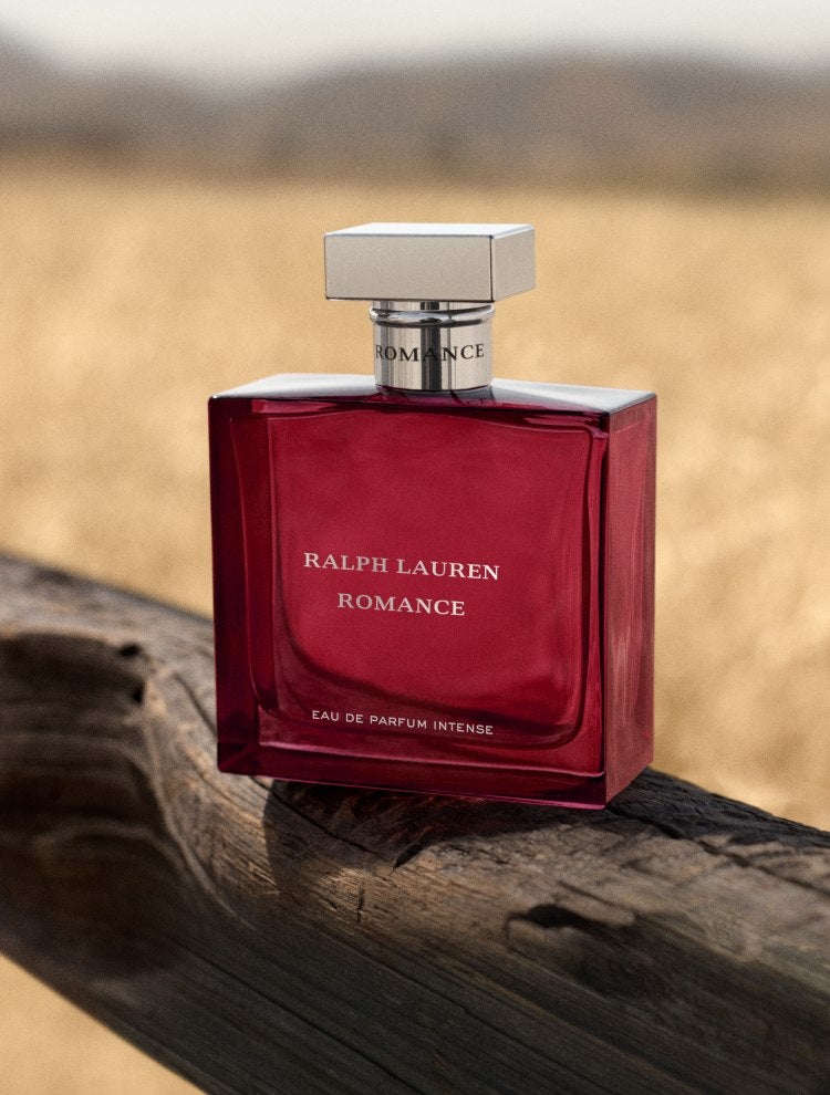 Pink fragrance bottle on wood log.
