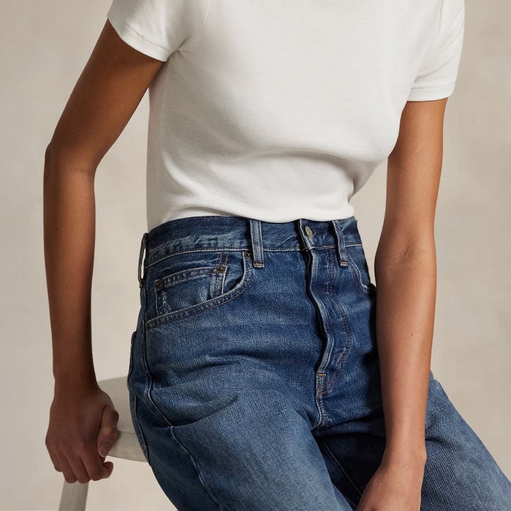 Woman wears straight jeans and white tee.