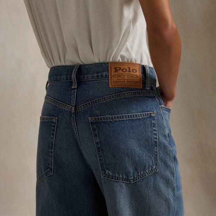Woman wears wide-leg jeans and white tee.