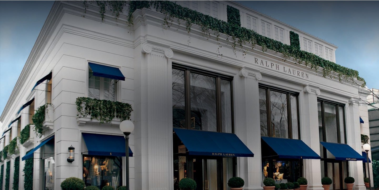 White facade of Tokyo flagship with blue awnings.