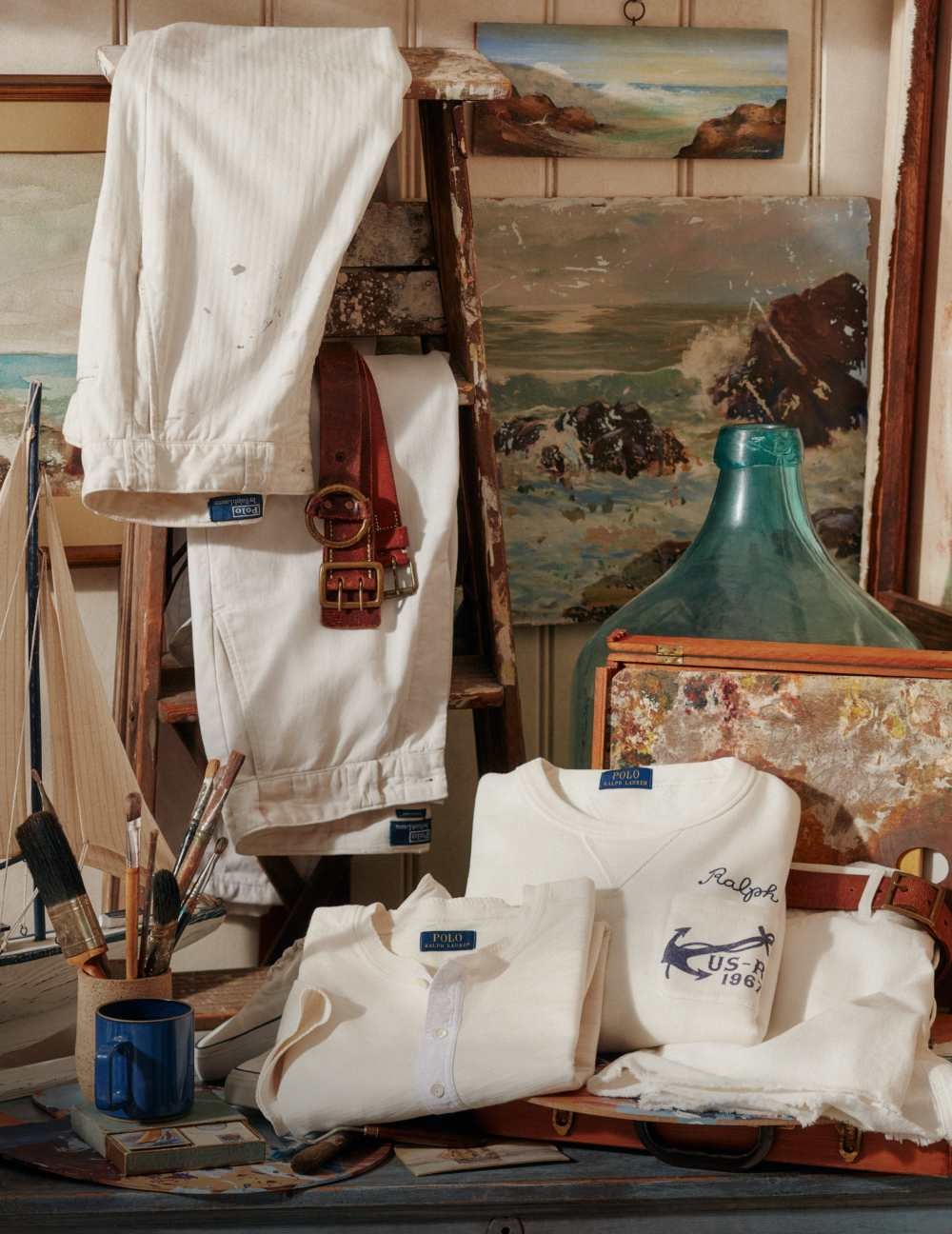 White pants and folded white shirts in artist&rsquo;s studio.