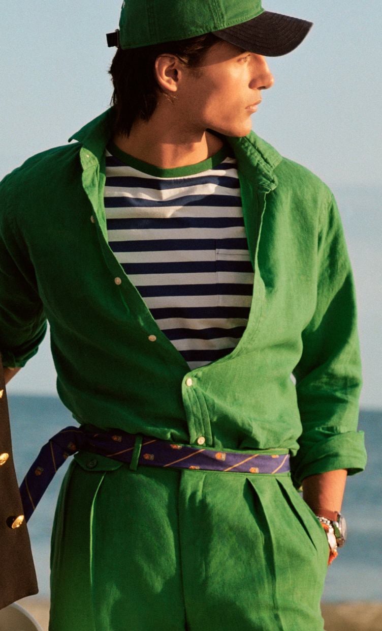 Man wears green linen button-down and green linen trousers.