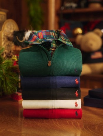 Folded red cable-knit sweaters.