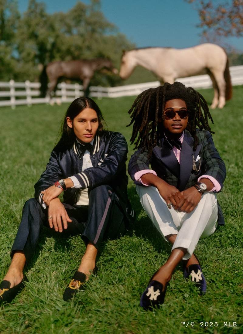 Men sitting on lawn wear Spring 2025 Polo attire.