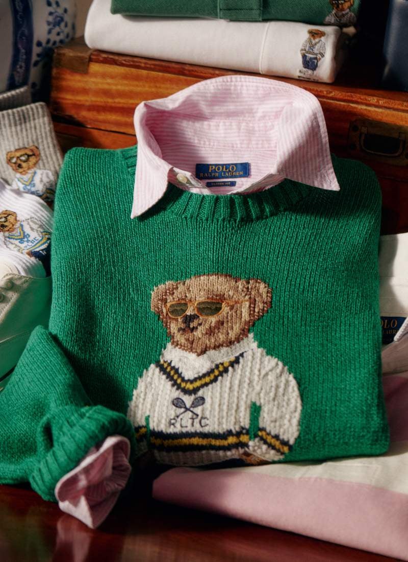Folded green sweater with Polo Bear at front.