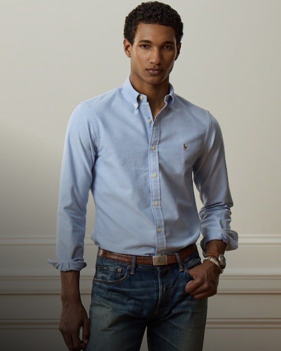 Man wears blue Slim Fit button-down shirt and jeans.