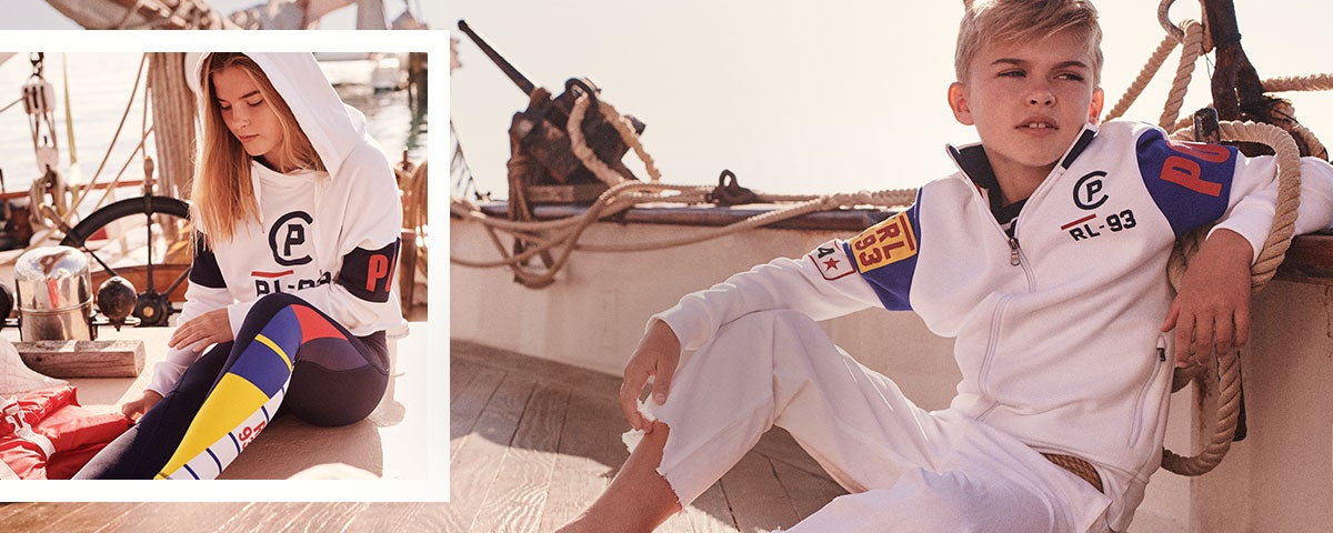 Boy and girl wear CP-93 designs on boat.