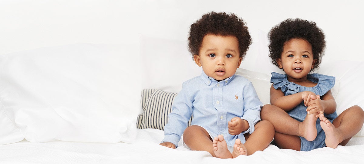 Baby boy in oxford shirt & baby girl in chambray romper