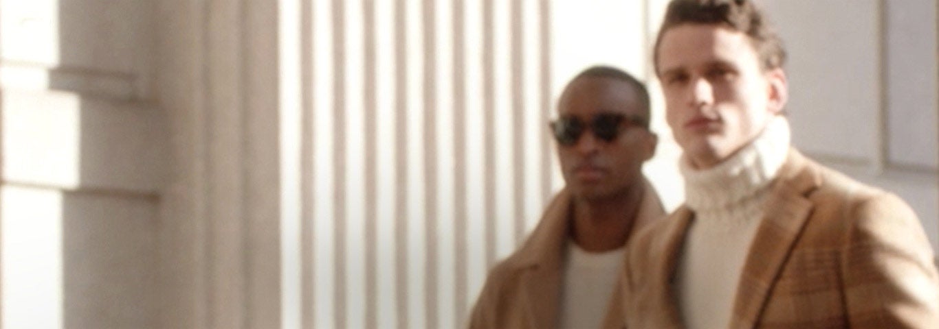 Men in cream tops paired layered with camel-hued coats