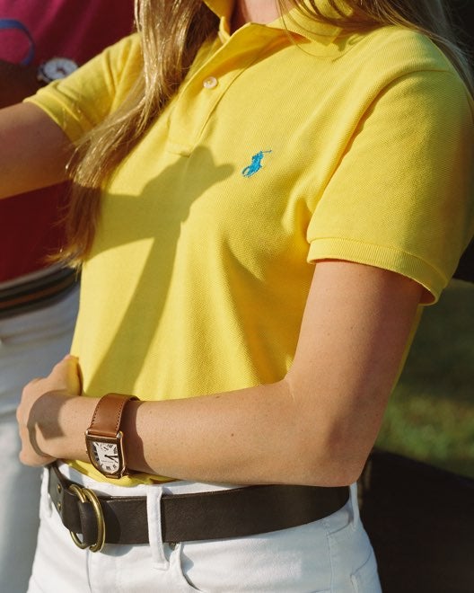Close-up of woman in yellow Polo shirt.