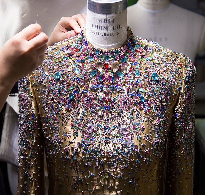 Intricate beading and unexpected utilitarian touches evoke the dream of an exotic safari