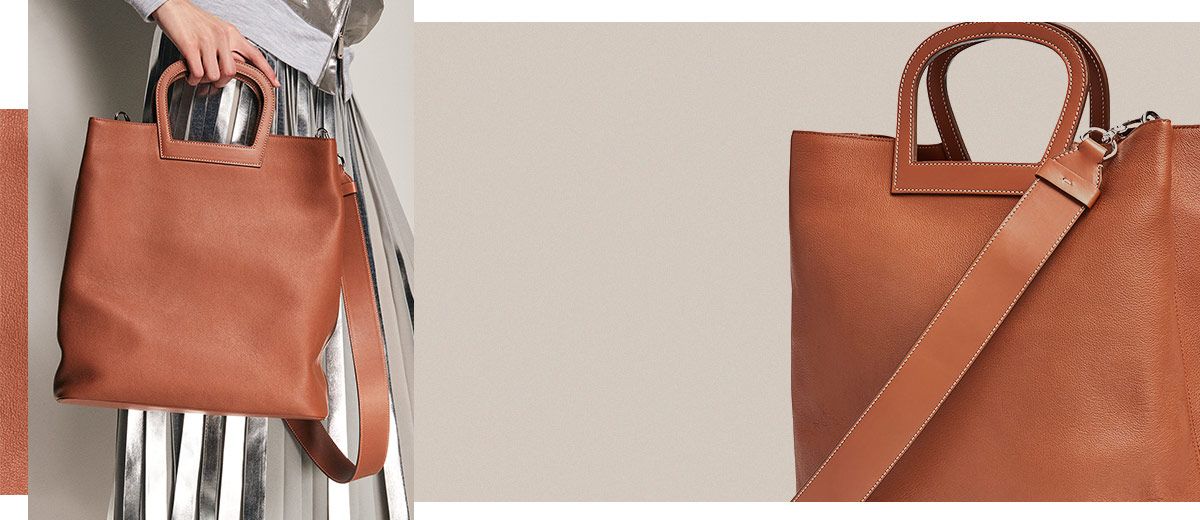 Brown leather tote with horseshoe-shaped handles
