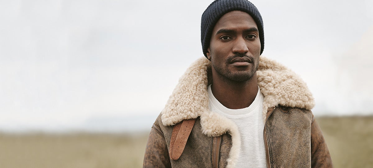 Man in shearling jacket, waffle-knit tee & black knit hat