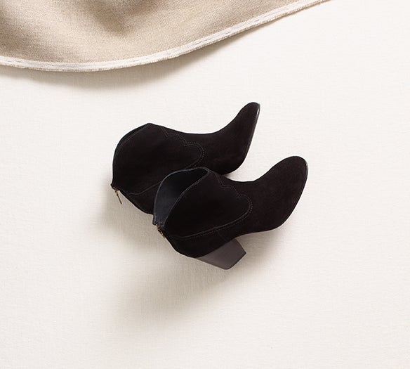 Black suede loafers with gold accent at toe