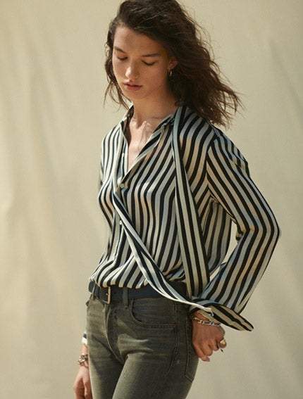 Woman in black-and-white striped tie-neck shirt