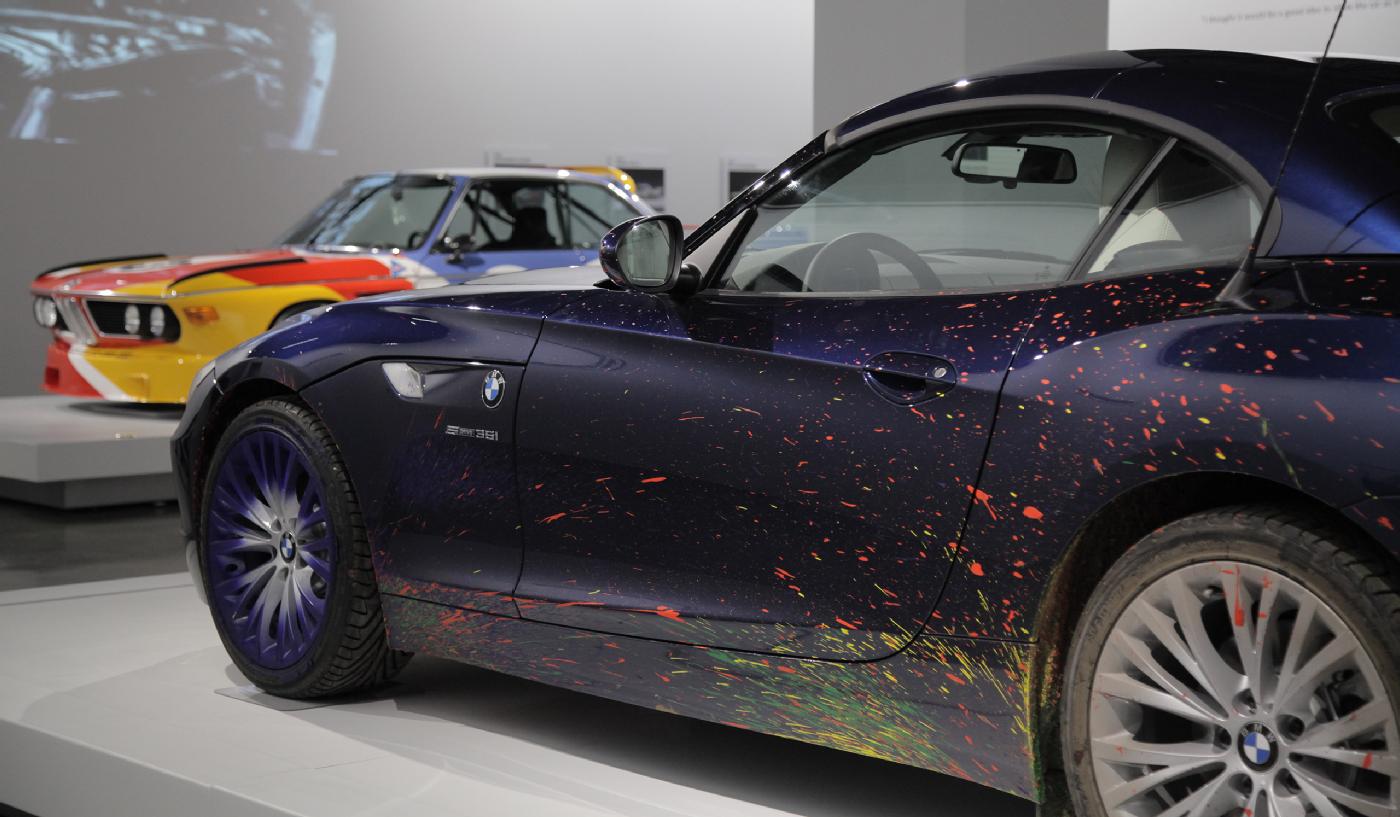 The 2009 BMW Z4 Roadster that artist Robin Rhode drove across a massive canvas (foreground) and a 1975 BMW 3.0 CSL painted by Alexander Calder are both part of the museum’s BMW Art Cars collection