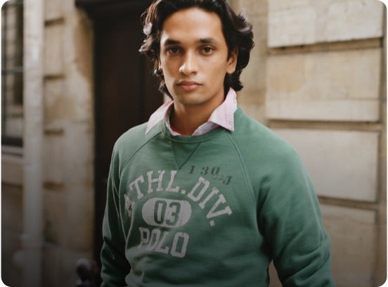Man in faded green Polo graphic sweatshirt.