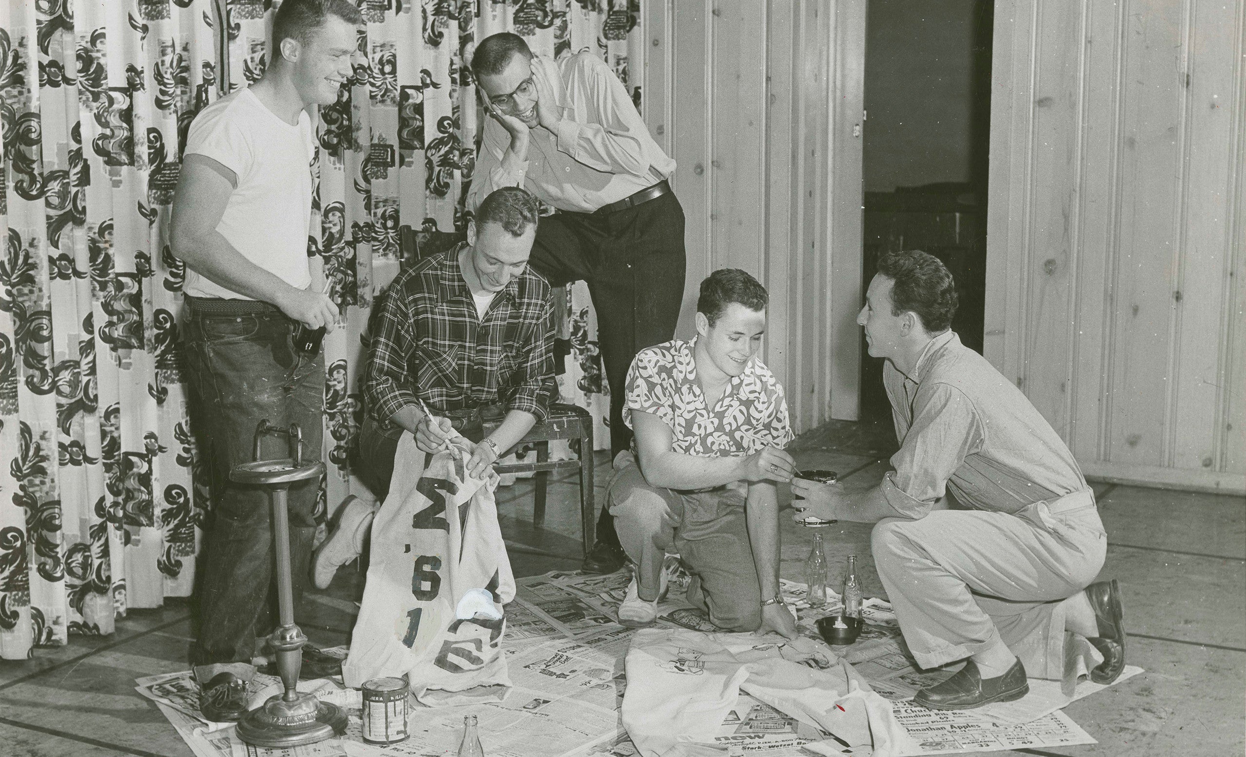 Members of the class of 1961 work on their cords