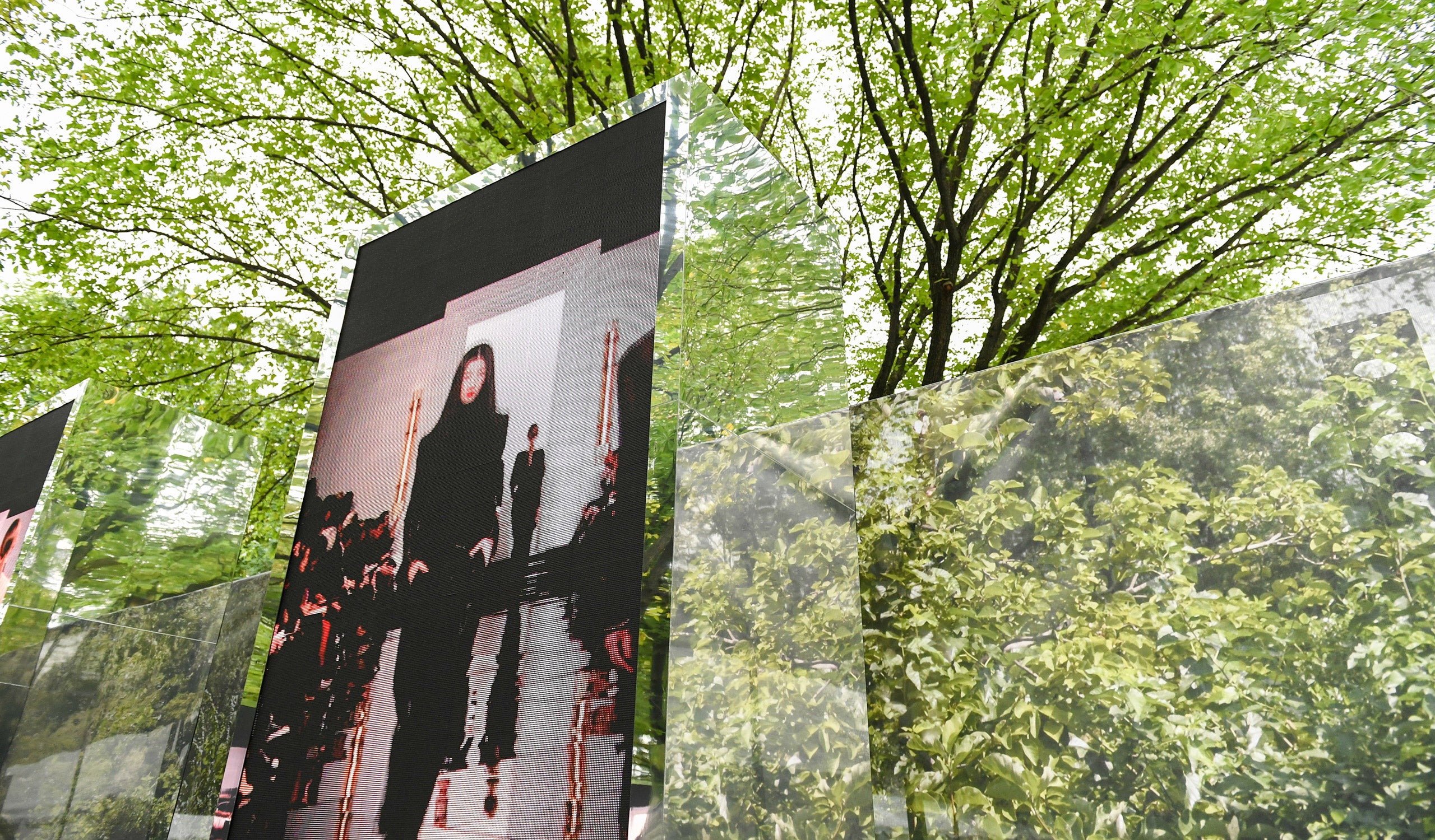 Models in iconic looks from past runway shows were displayed on mirrored monolithic installations