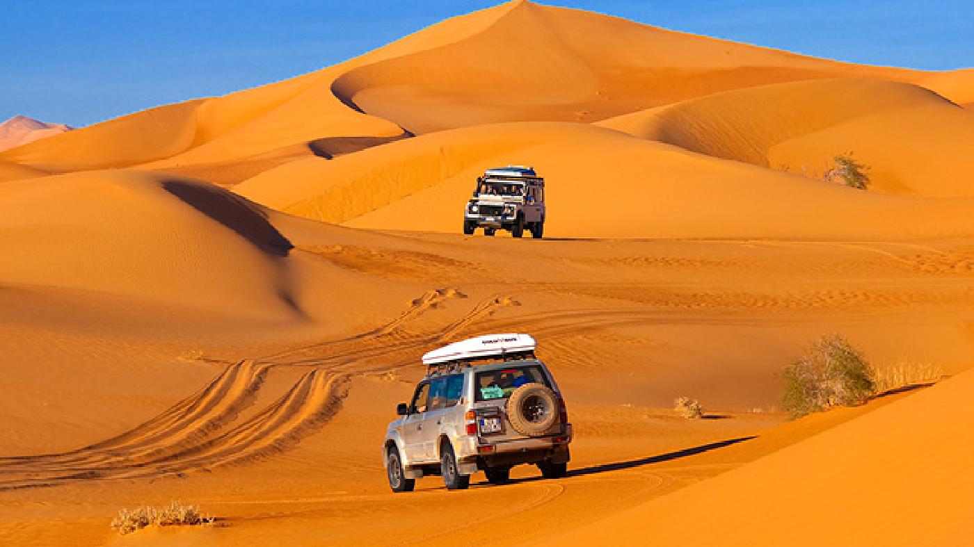A Defender (top) and a Toyota make tracks in the Sahara Desert’s Ubari dunes