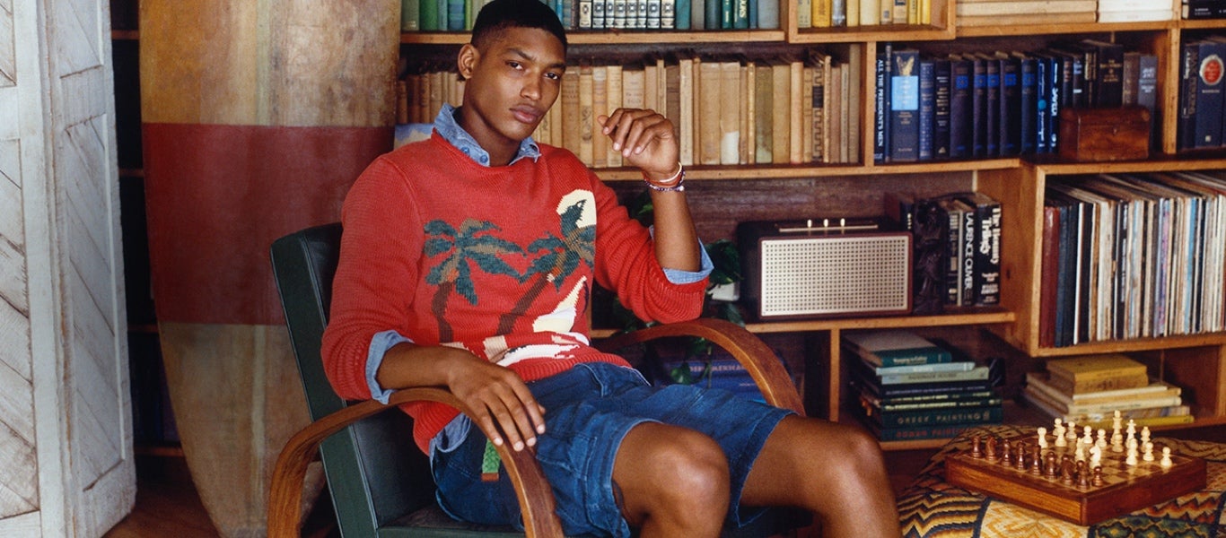 Man in orangey-red sweater with palm tree graphic