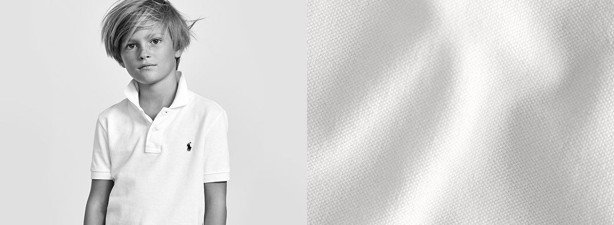 Black-and-white image of boy in Polo shirt.