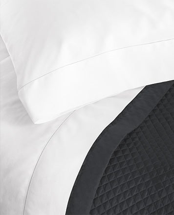 White sheets a paired with dark grey duvet