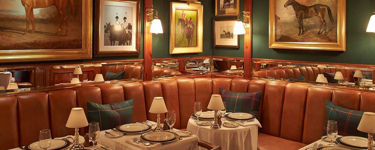 Leather banquettes & plaid cushions at The Polo Bar in NYC