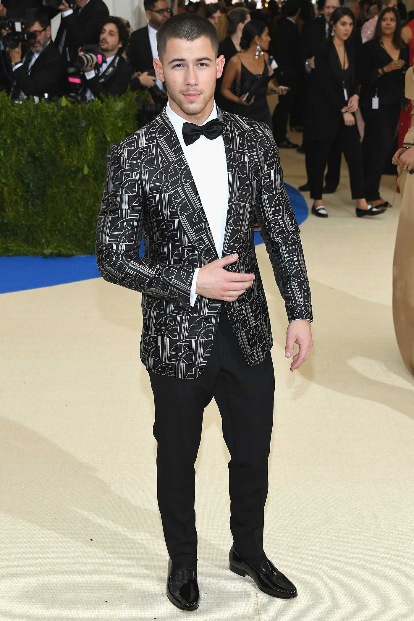 Nick Jonas wore a graphic, Art Deco–inspired jacquard dinner jacket and tuxedo pants from Ralph Lauren Purple Label