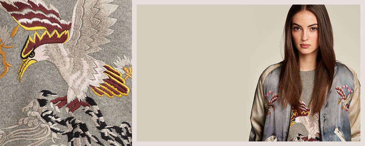 Model in eagle-embroidered grey sweatshirt & bomber jacket