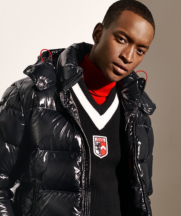 Man in high-shine black quilted down coat