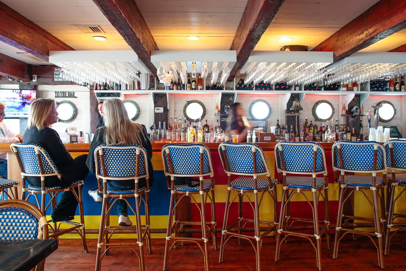 The Navy Beach restaurant bar, lined with porthole windows and a nautical-inspired paint job