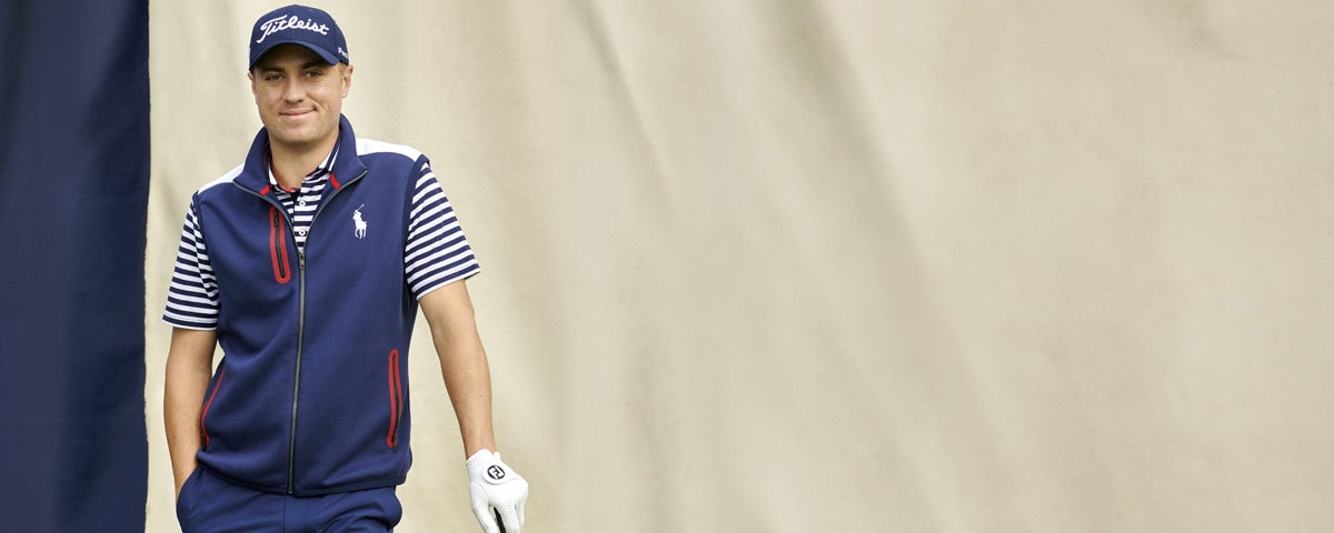 Justin Thomas in navy vest, striped tee & navy pants